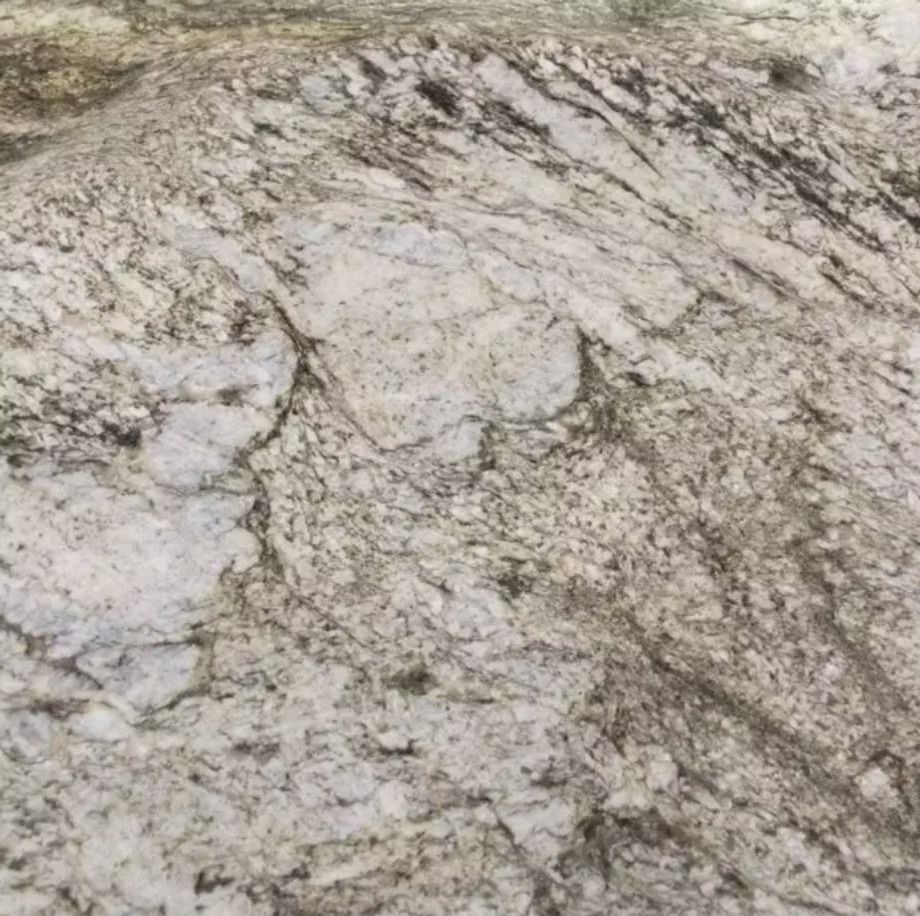 Close-up of a white and gray granite countertop with dark gray veining.
