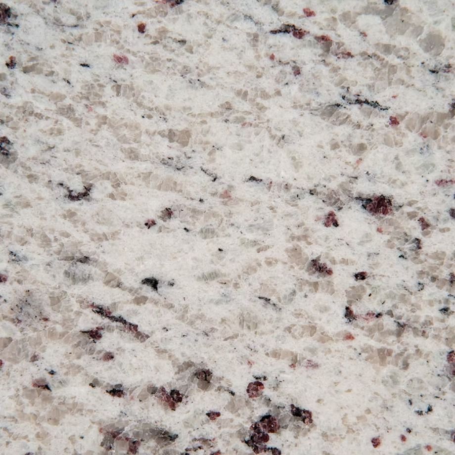 White granite countertop with flecks of brown and red.