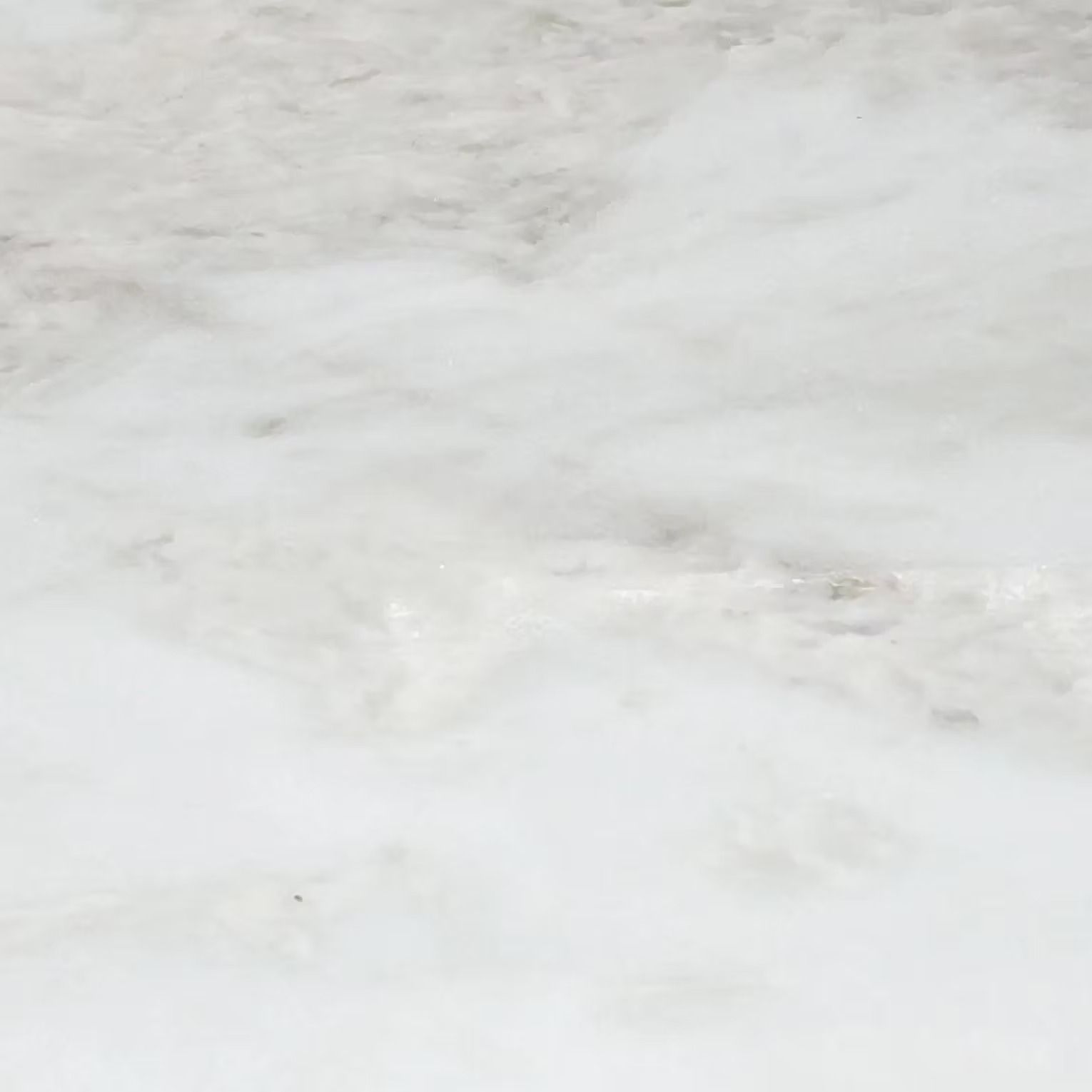 White marble surface with gray veining.