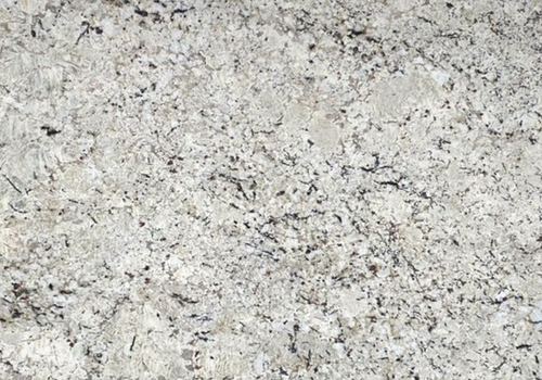 Close-up of a white granite countertop with black and gray speckles and veining.