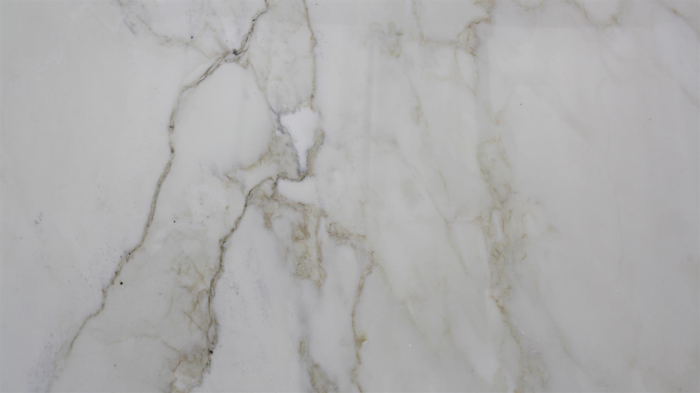 White marble surface with gray and brown veining.