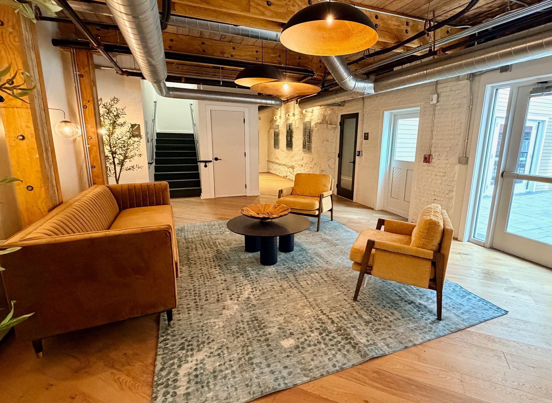 A couch with a pillow on it is sitting next to a table.