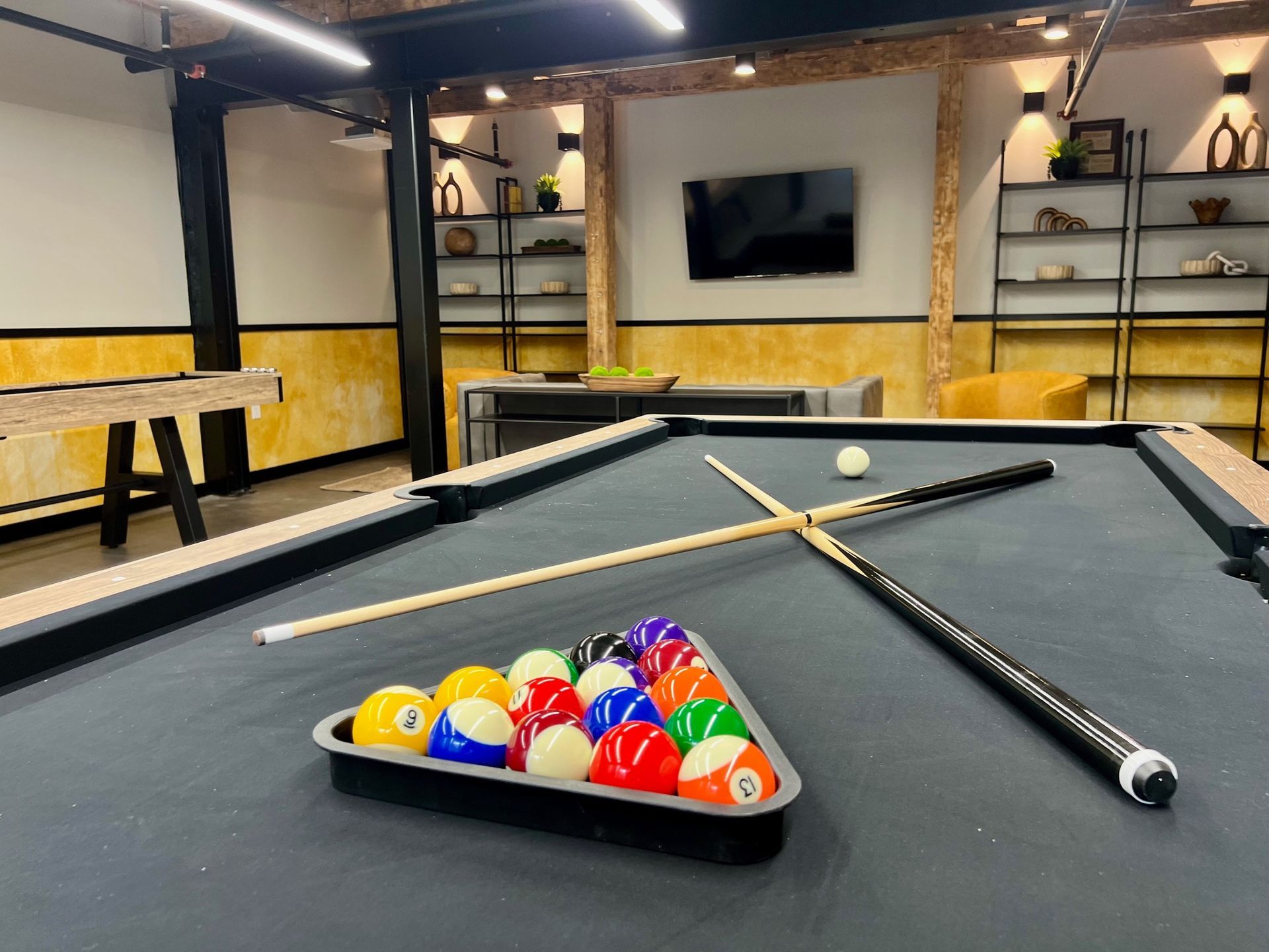 A pool table with balls and cues on it