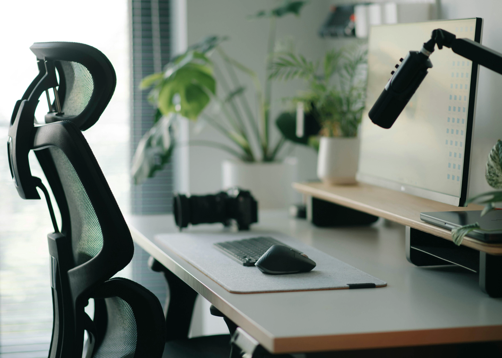 A desk with a computer and a microphone on it