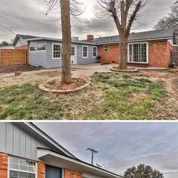 Backyard view of a gray-and-brick house with two trees and a patchy lawn