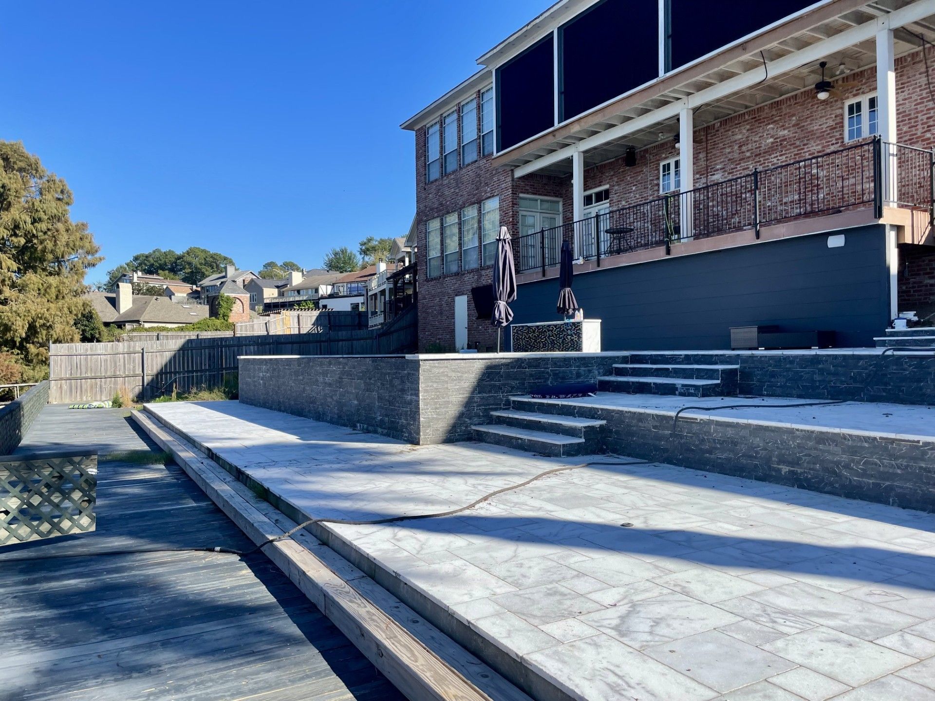 Man in cowboy hat exiting a Bobcat skid-steer loader on a construction site.