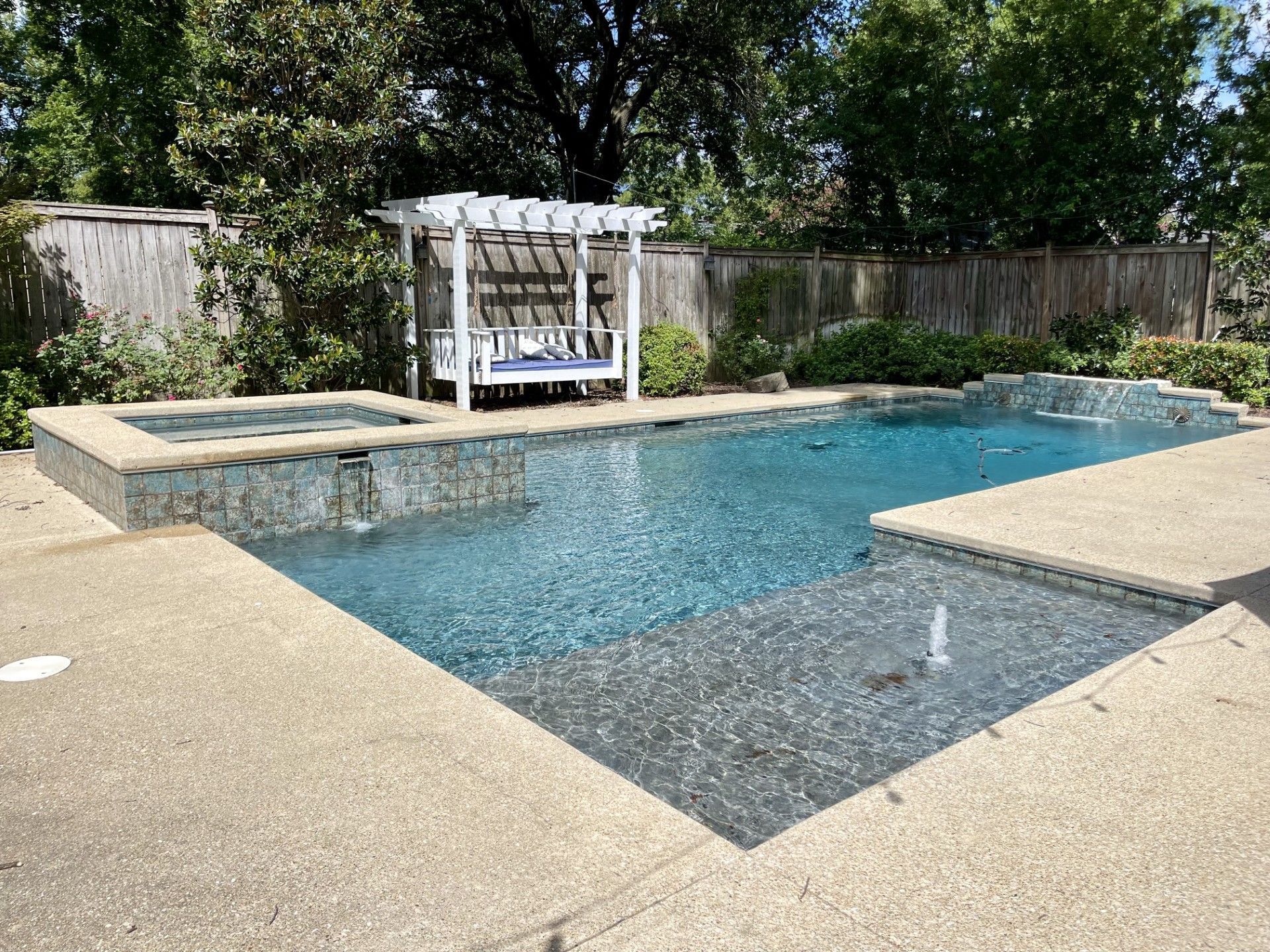 A swimming pool is being built in the backyard of a house