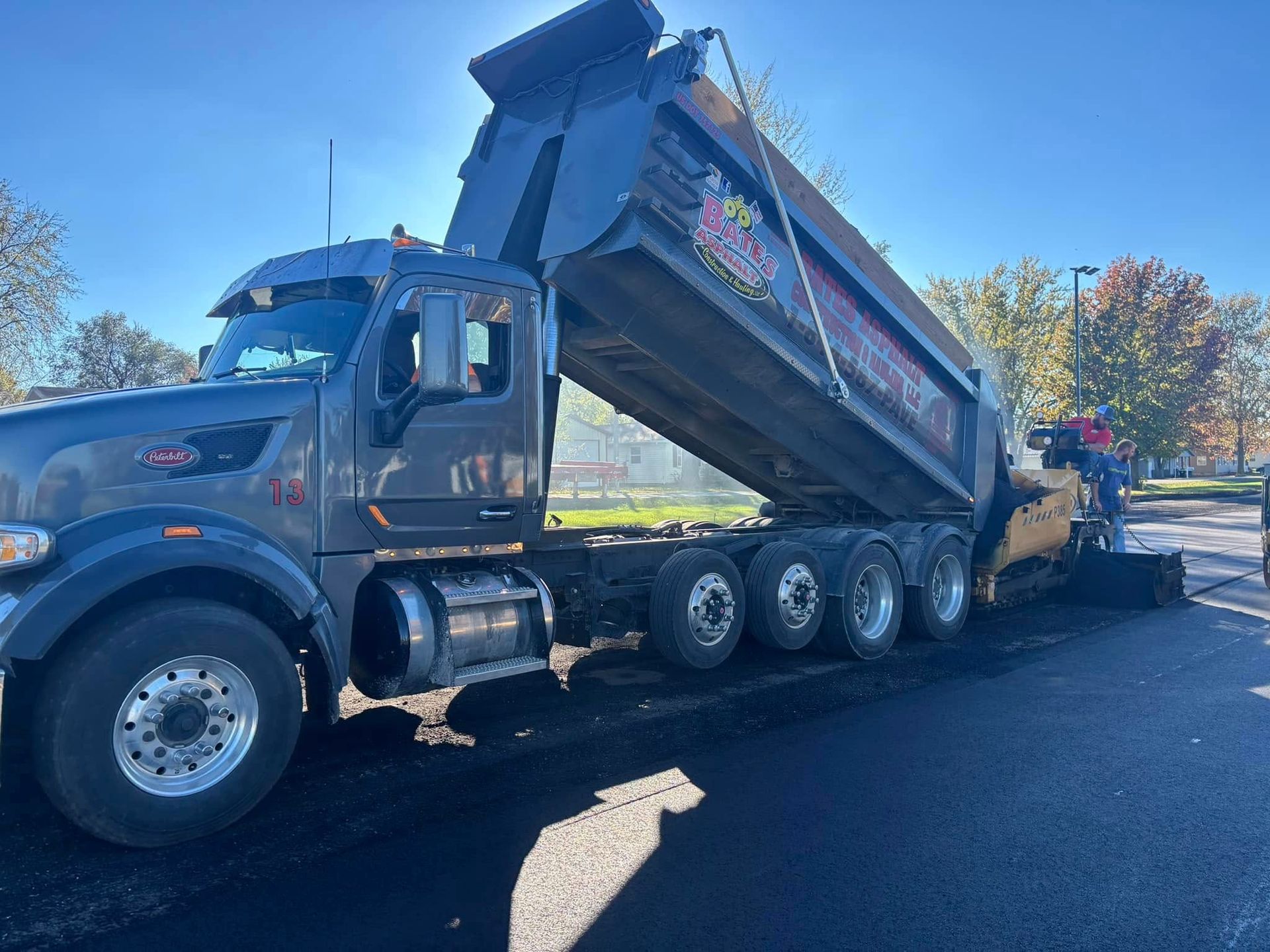 A dump truck is parked on the side of the road.