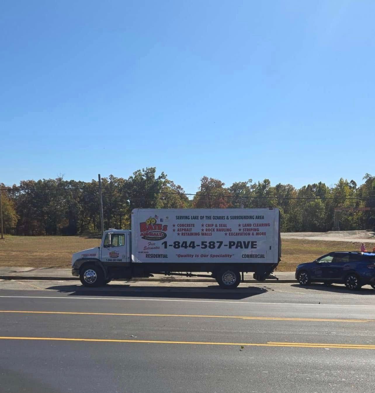 A white truck is parked on the side of the road.