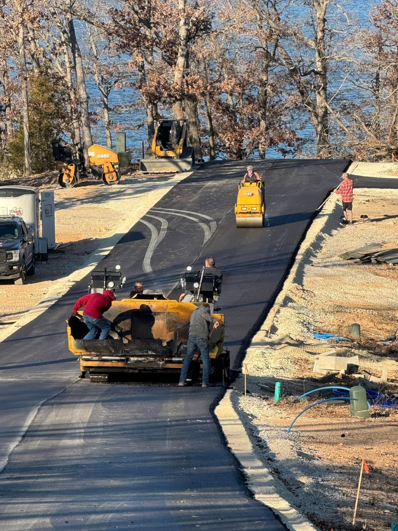 A group of construction workers are working on a road.