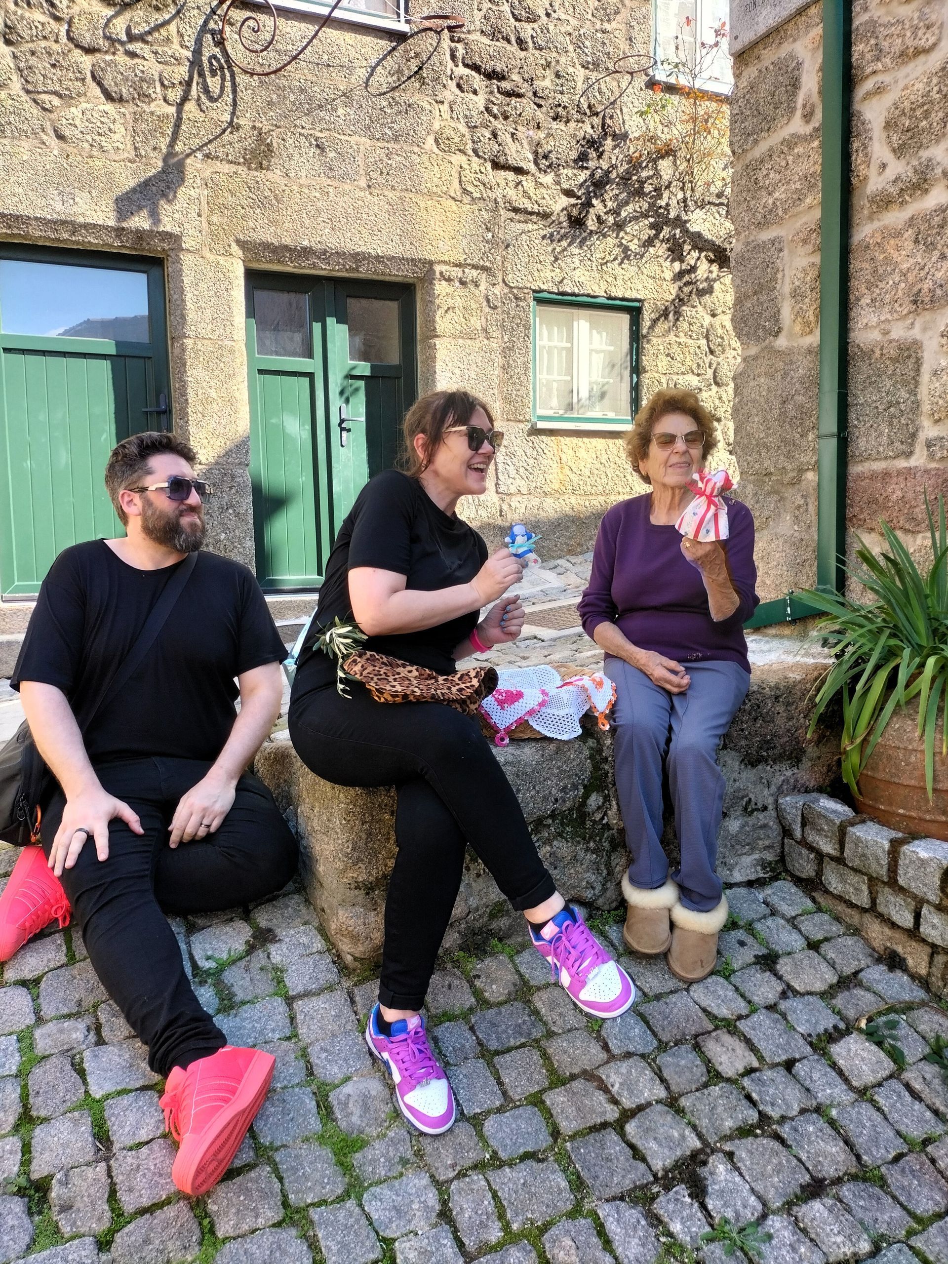 Traveling couple happily in contact with a Monsanto local on the Game of Thrones guided tour from Lisbon.