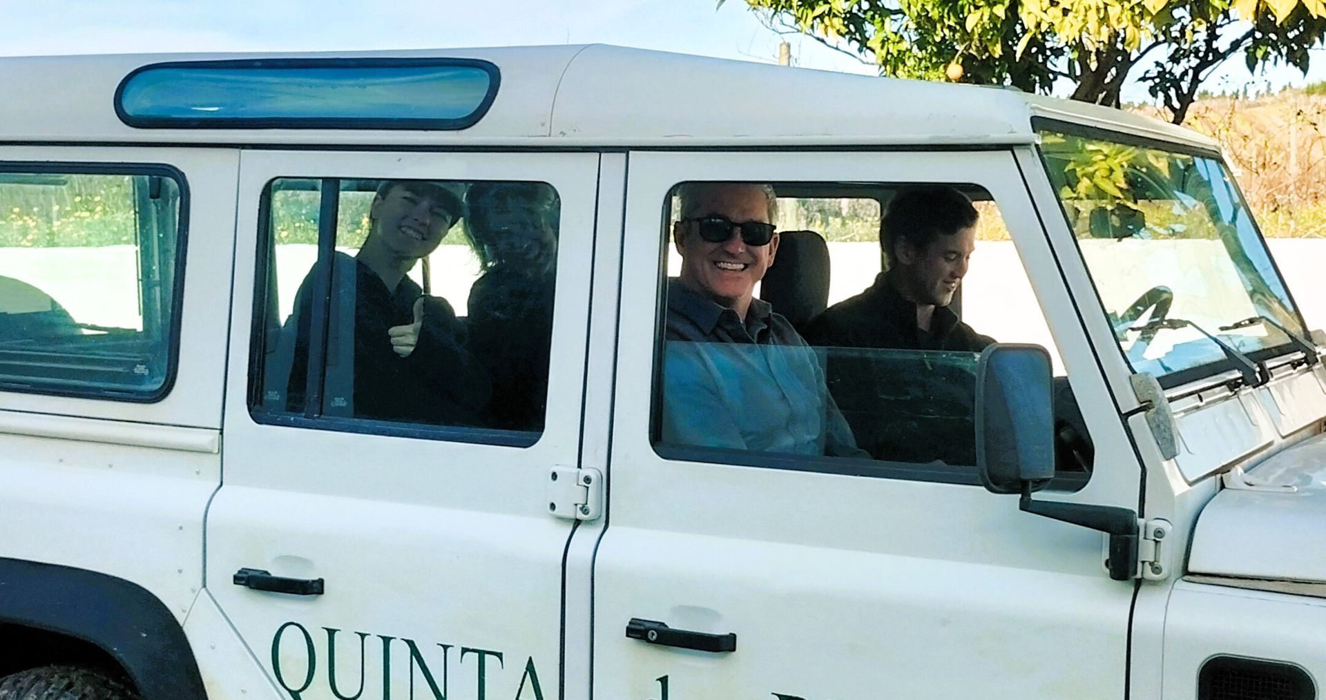 A group of happy travelers in a 4wd on their way to a vineyard tour near Lisbon in Portugal during a wine tour from Lisbon.