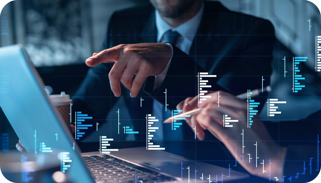 Two businesspeople in suits collaborate over a laptop, pointing at data visualizations.
