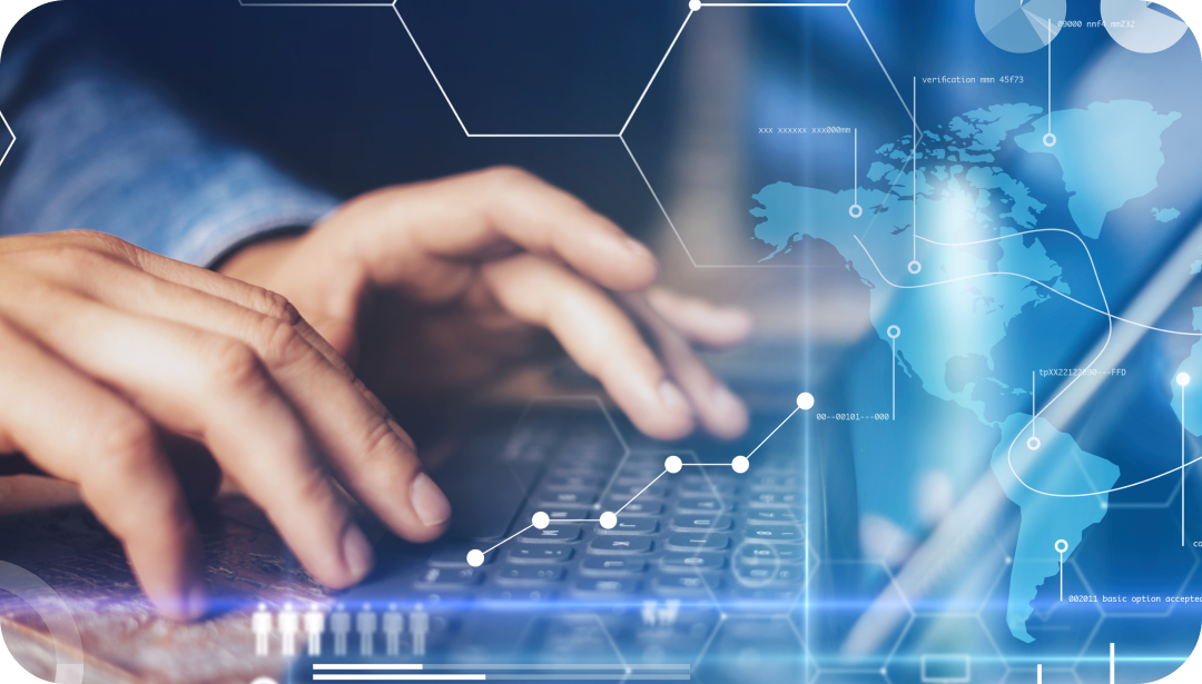 Hands typing on a keyboard with a glowing blue digital overlay including a world map and data visualization.
