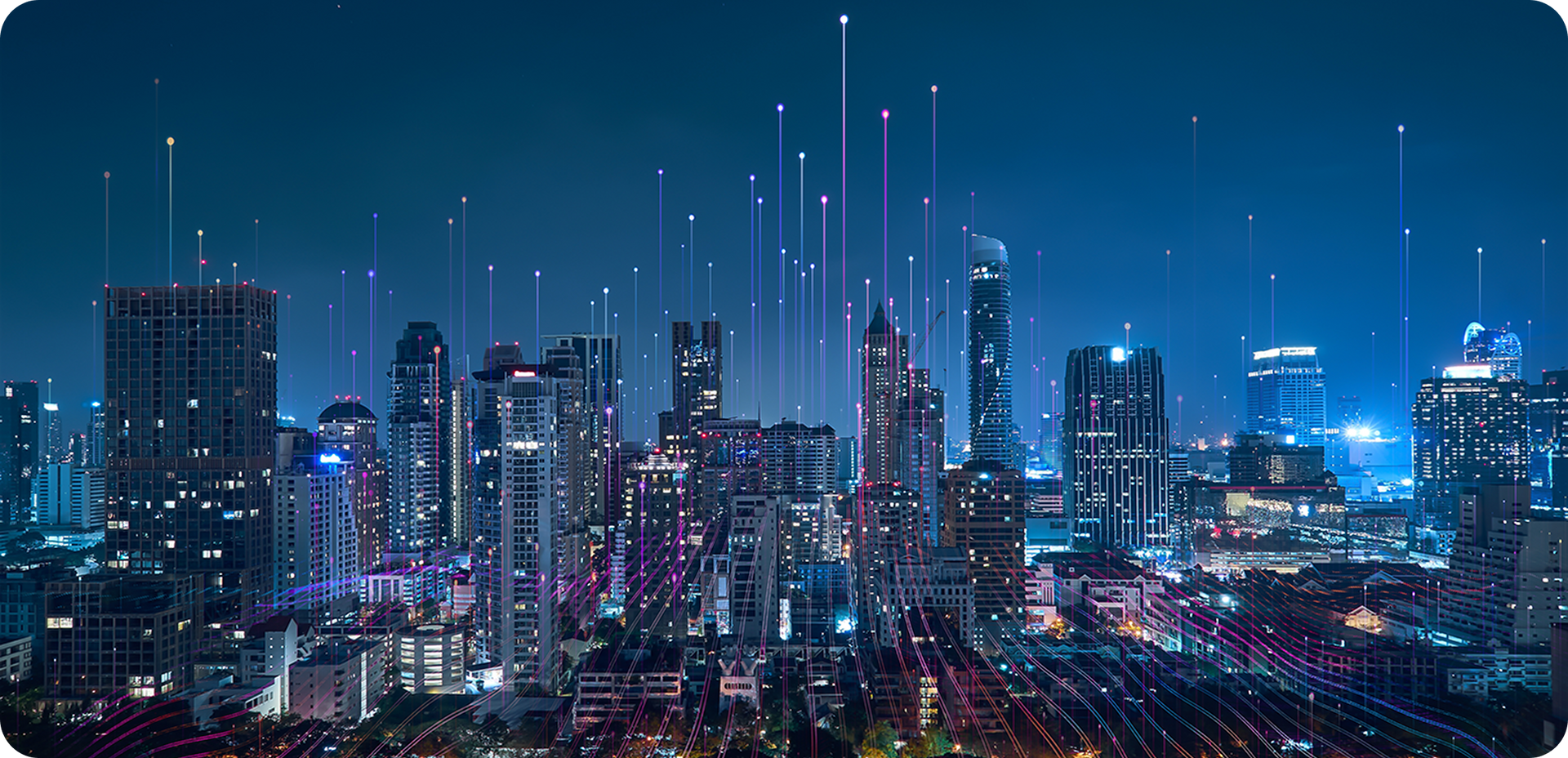 A nighttime cityscape with glowing lights, interconnected by vertical lines, under a dark blue sky.