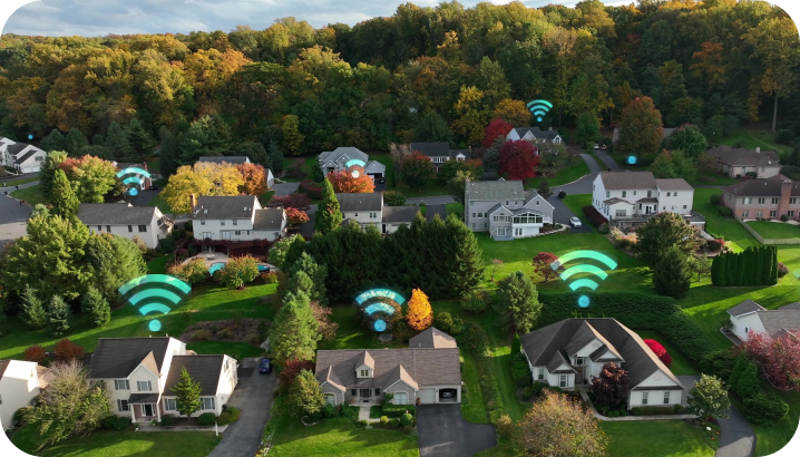 An aerial view of a residential neighborhood with WiFi signal icons above houses, suggesting internet access.
