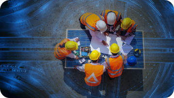 Construction workers in hard hats and vests reviewing blueprints outdoors.