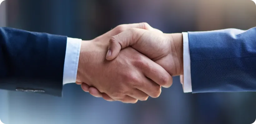 Two people shaking hands in a business deal, close up, showing agreement. Two people shaking hands in a business deal, close up, showing agreement.