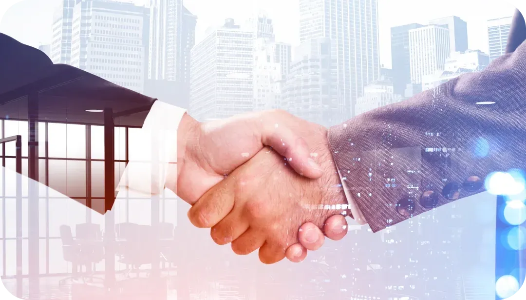 Two business people shaking hands, city skyline background.