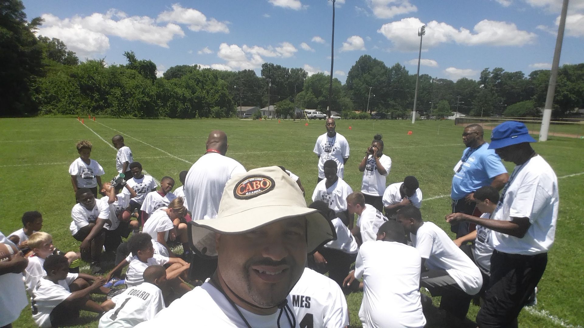 A man wearing a hat with the word mlb on it