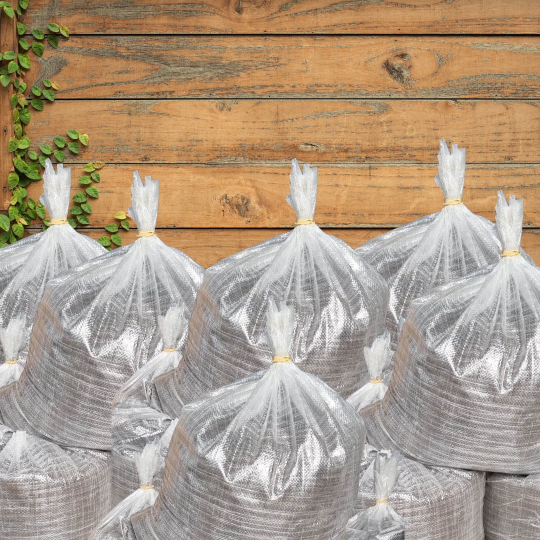 A bunch of bags sitting on top of each other on a wooden table