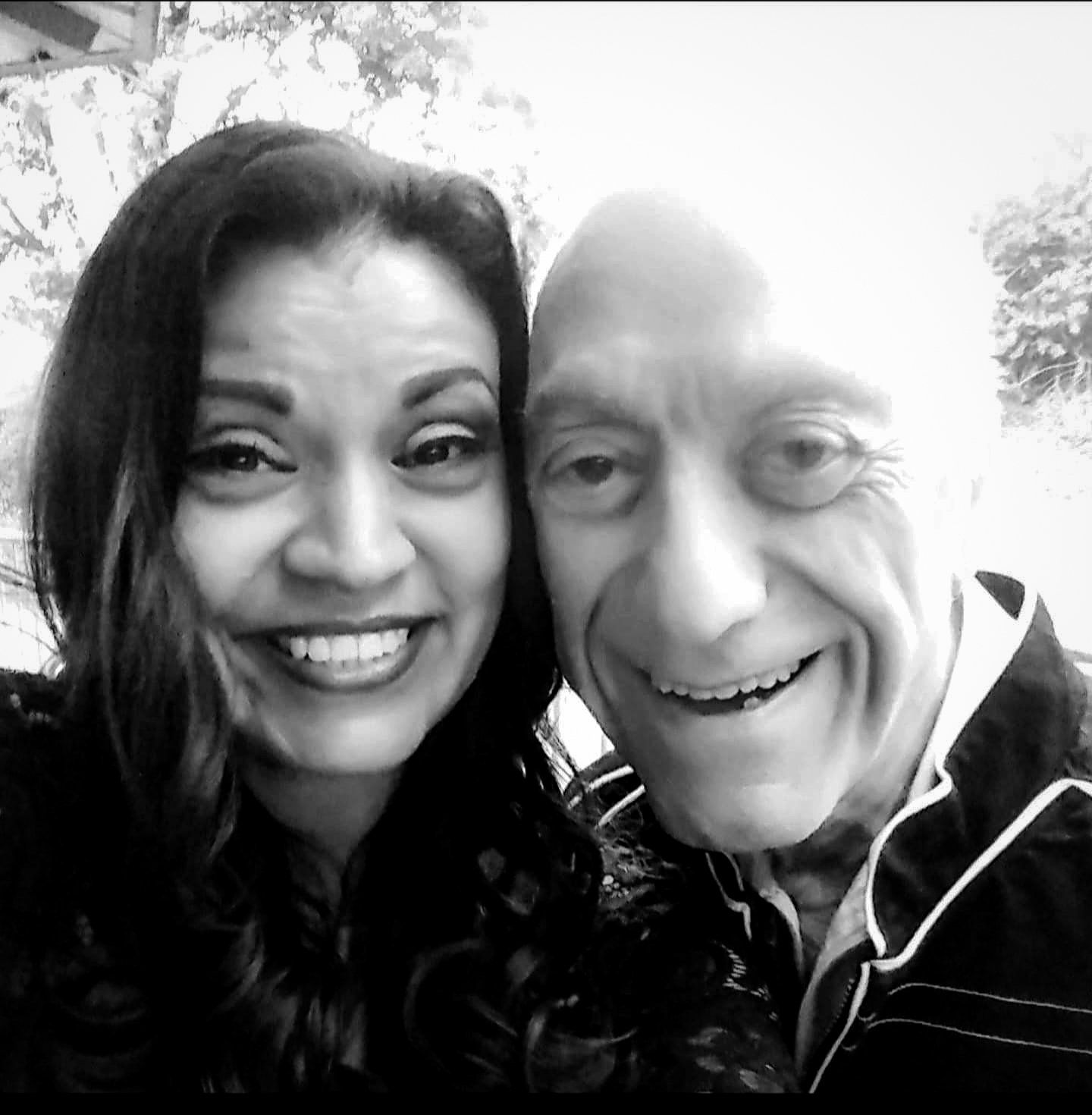 A black and white photo of a man and a woman smiling