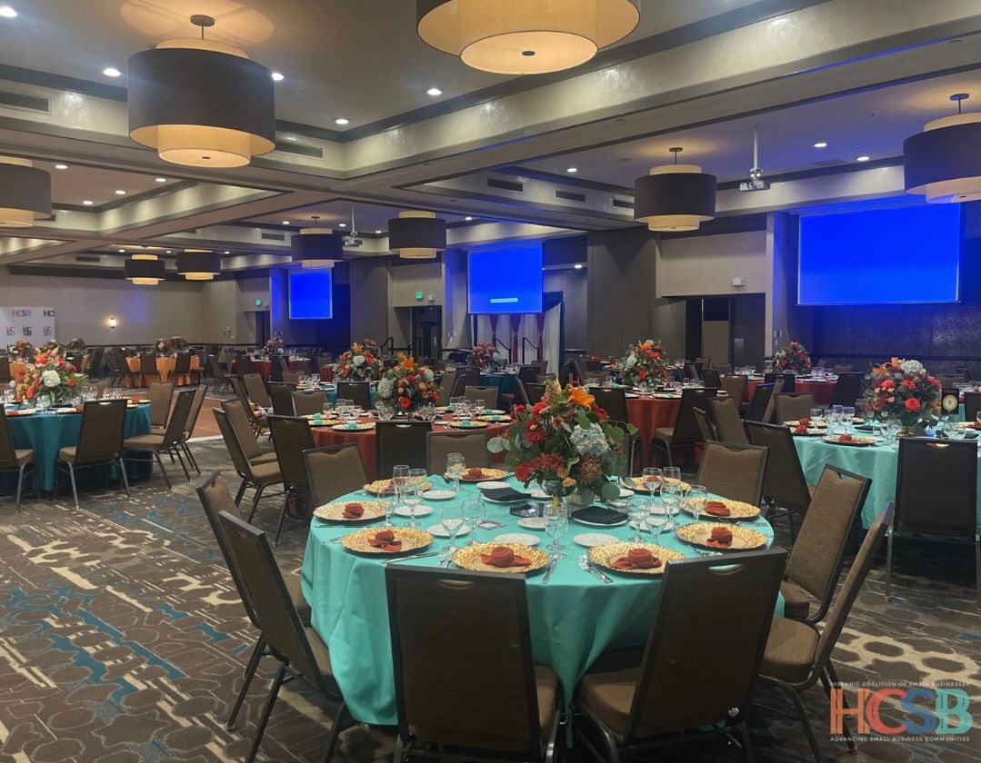 A large room with tables and chairs set up for a banquet.