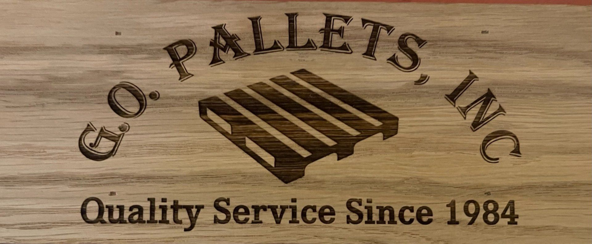 A wooden sign that says pallets inc quality service since 1984