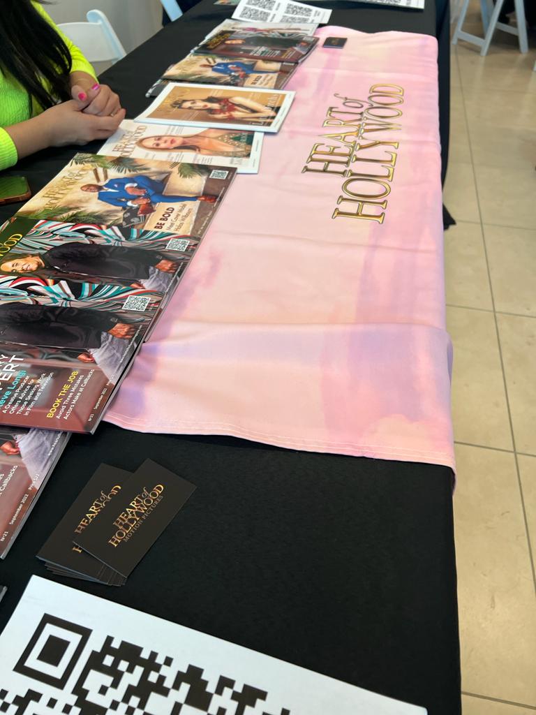 A table with a pink table runner that says heart hollywood