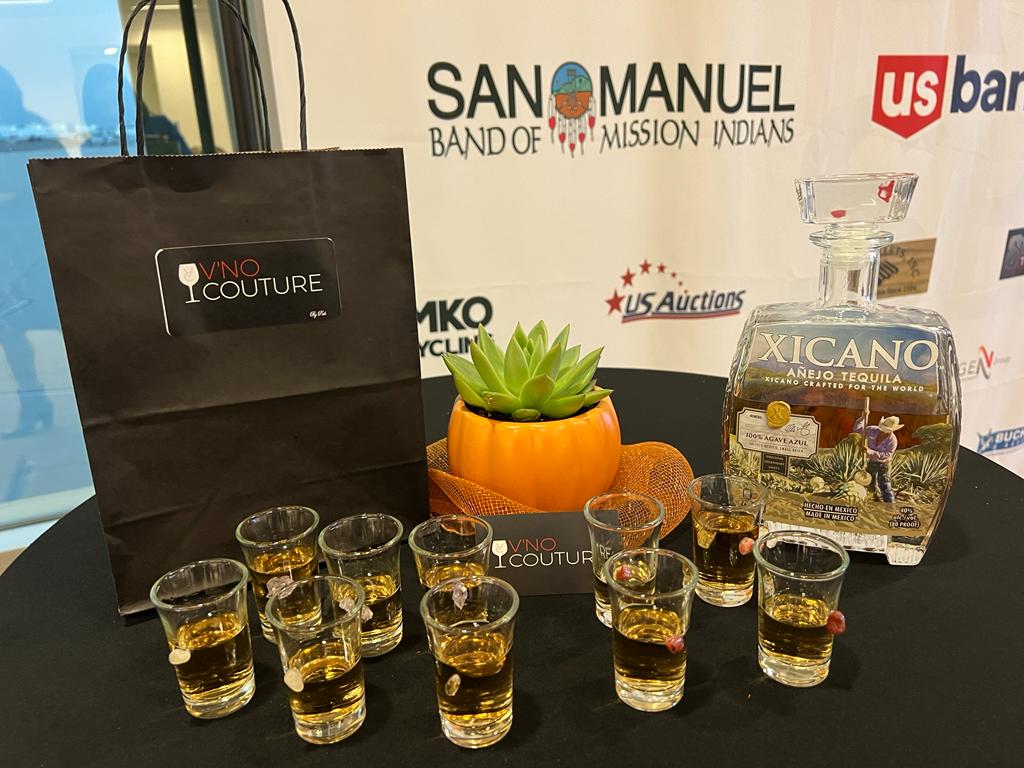 A table with shot glasses and a bottle of tequila