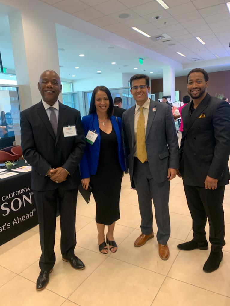 A group of people standing next to each other in a room.