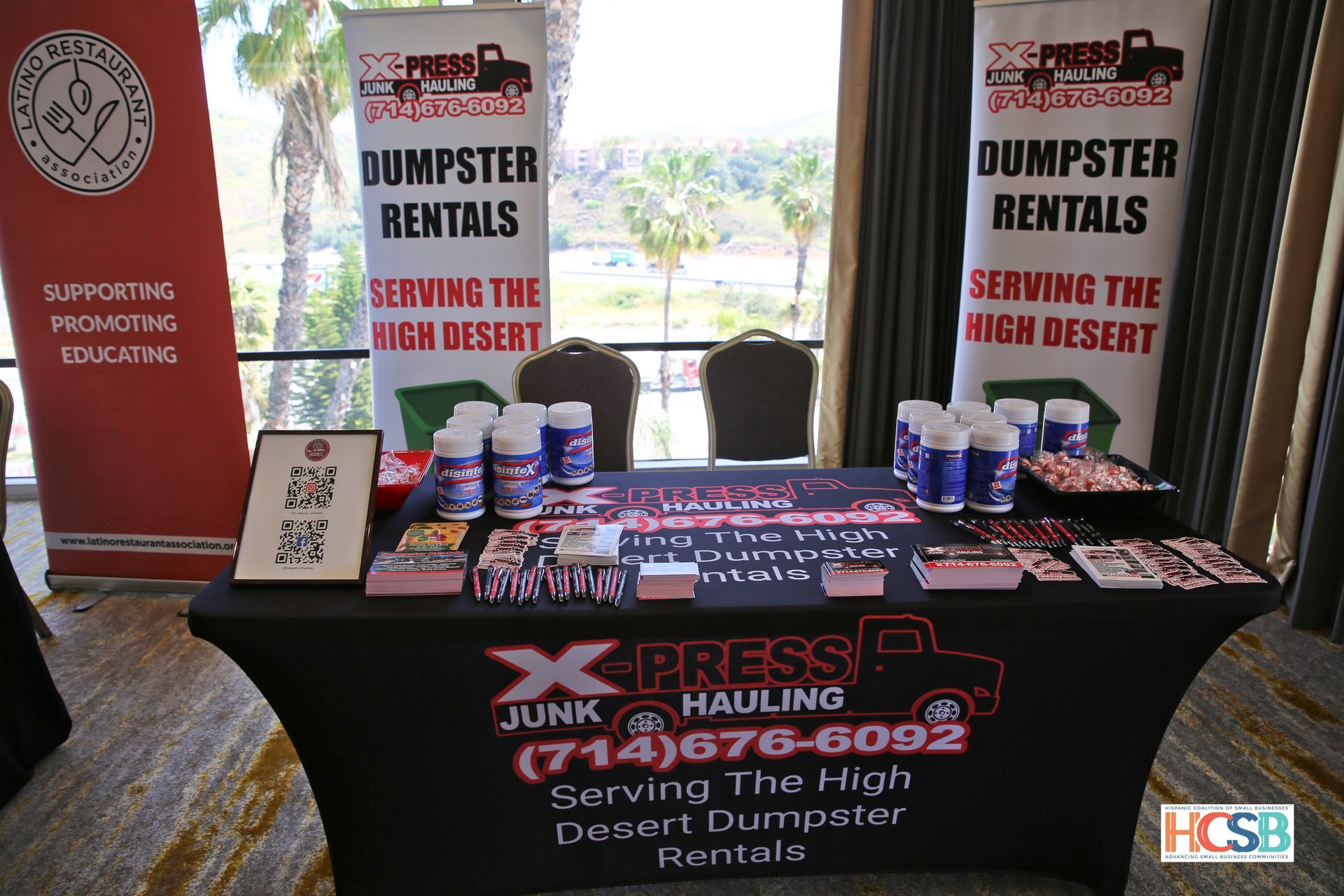 A table with a sign that says dumpster rentals on it