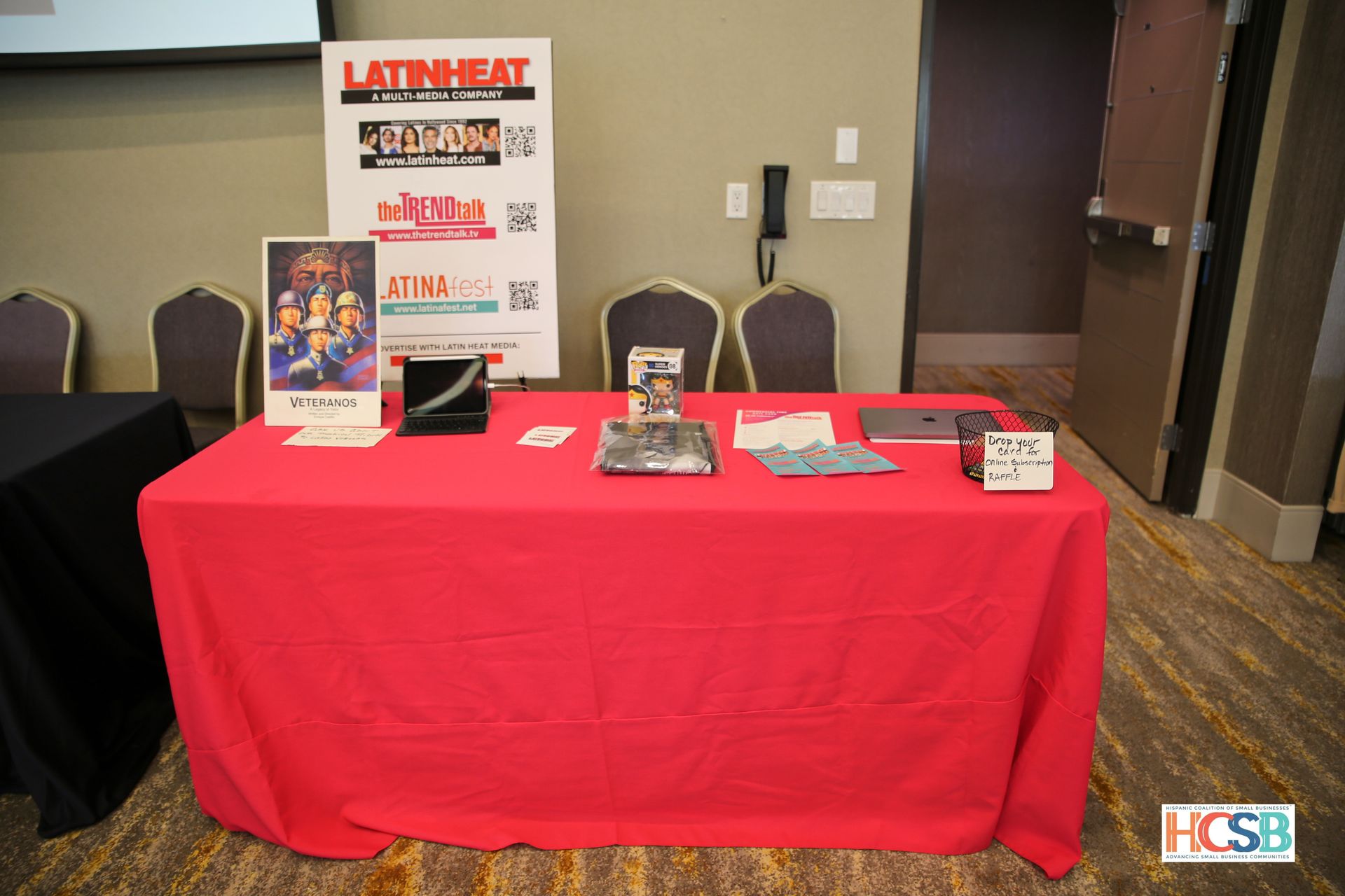 A table with a red table cloth and a sign that says latin heat