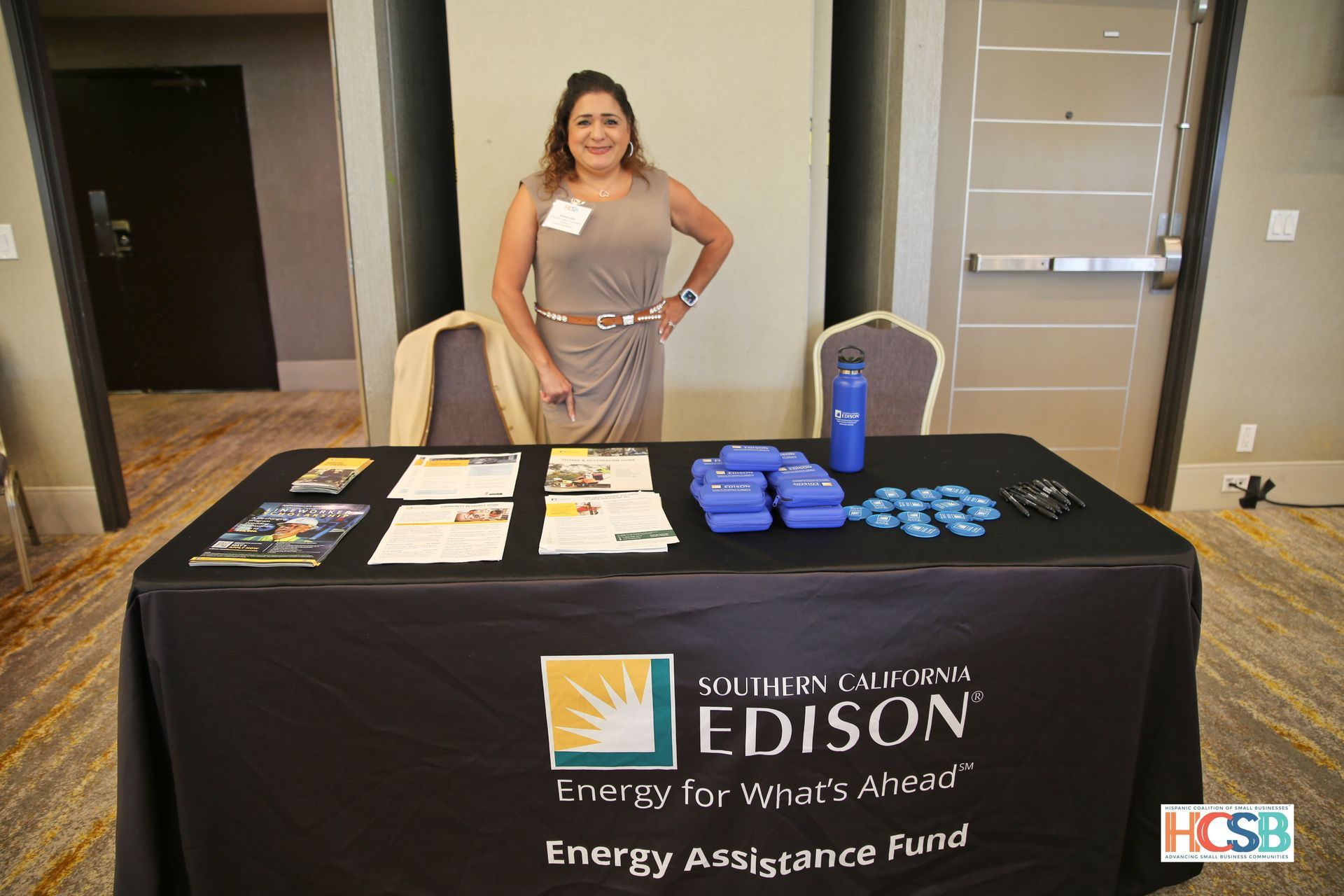 A woman is standing in front of a edison table