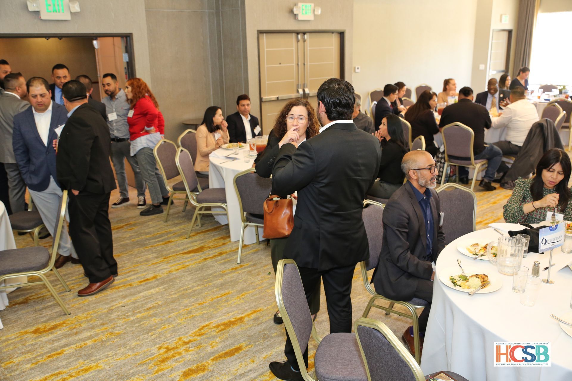 A group of people are sitting at tables in a room.