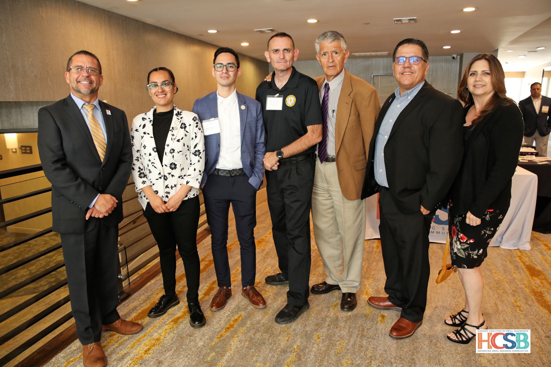 A group of people standing next to each other in a room.
