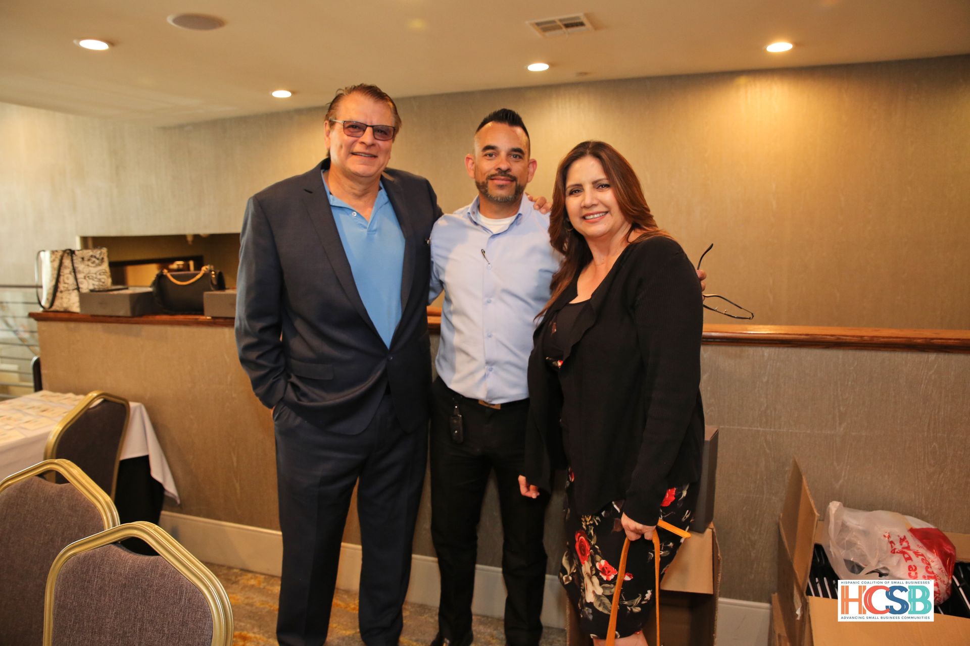 Three people are posing for a picture in a room.