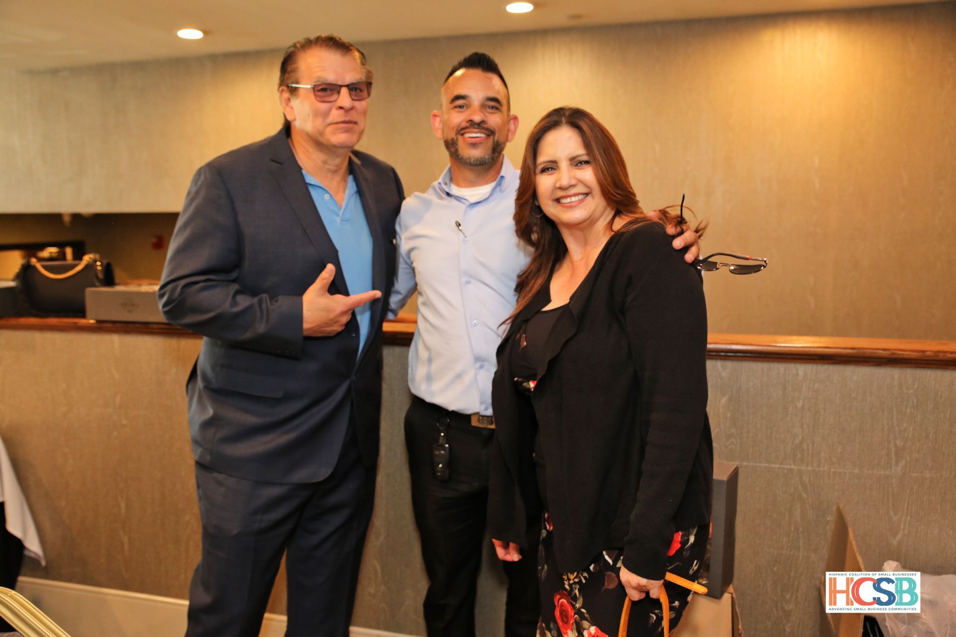 A man in a suit and a woman in a black dress are posing for a picture.