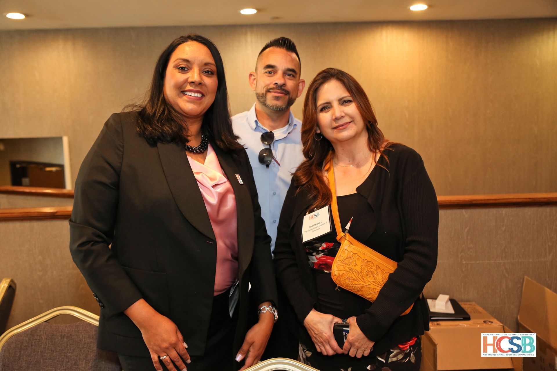 Three people are posing for a picture together in a room.
