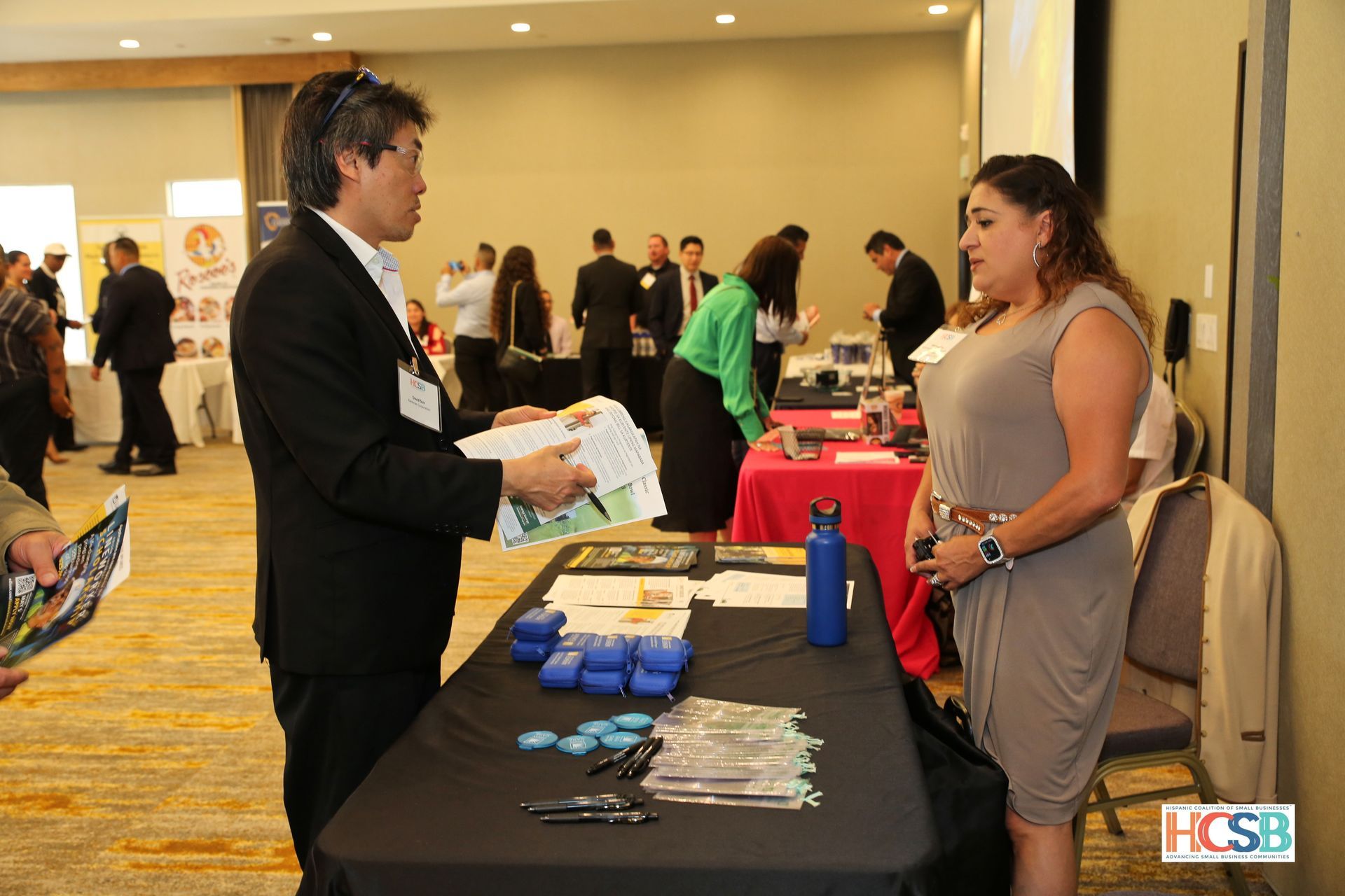 A man is talking to a woman at a job fair