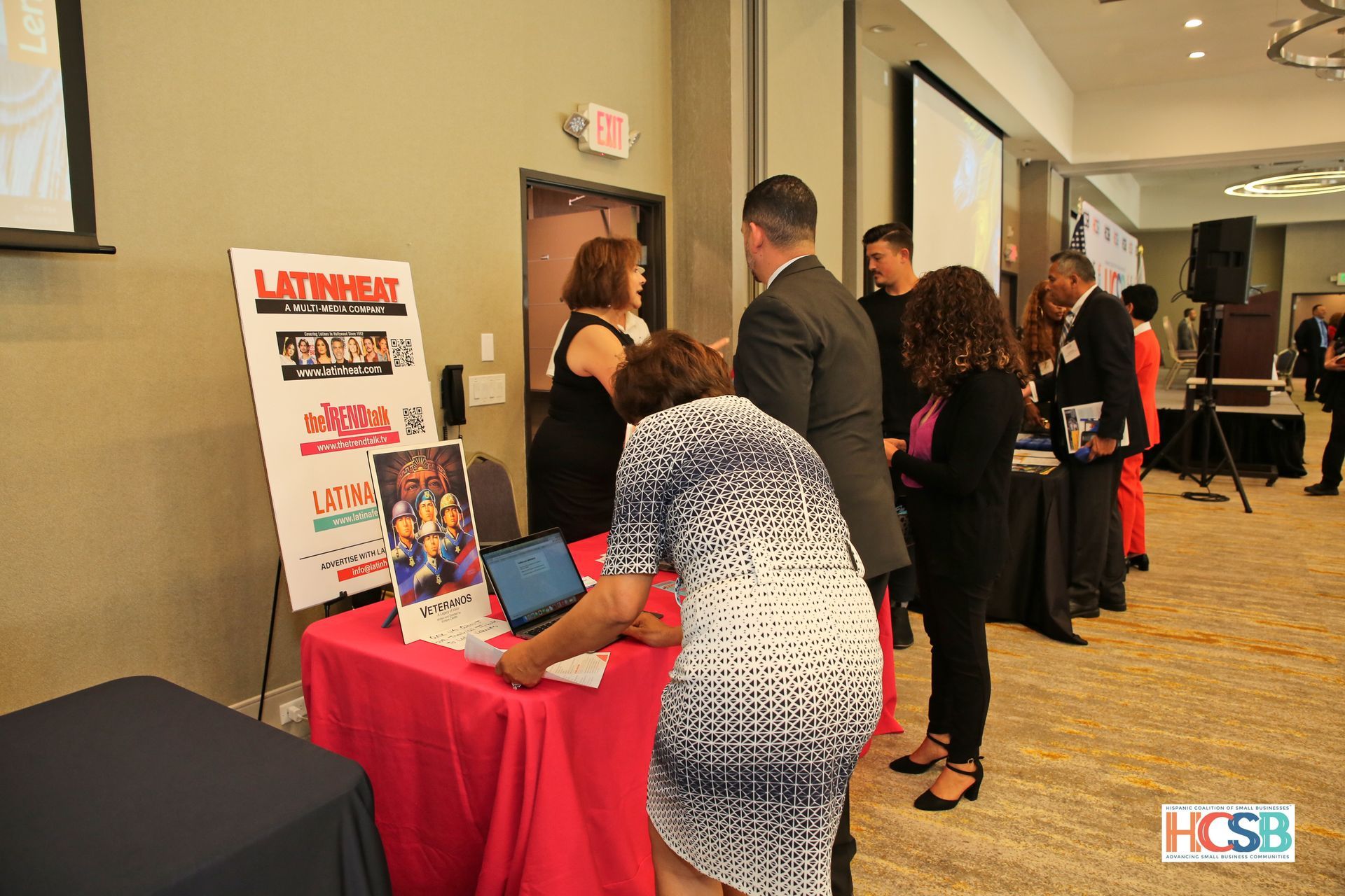 A group of people are standing around a table in a room.