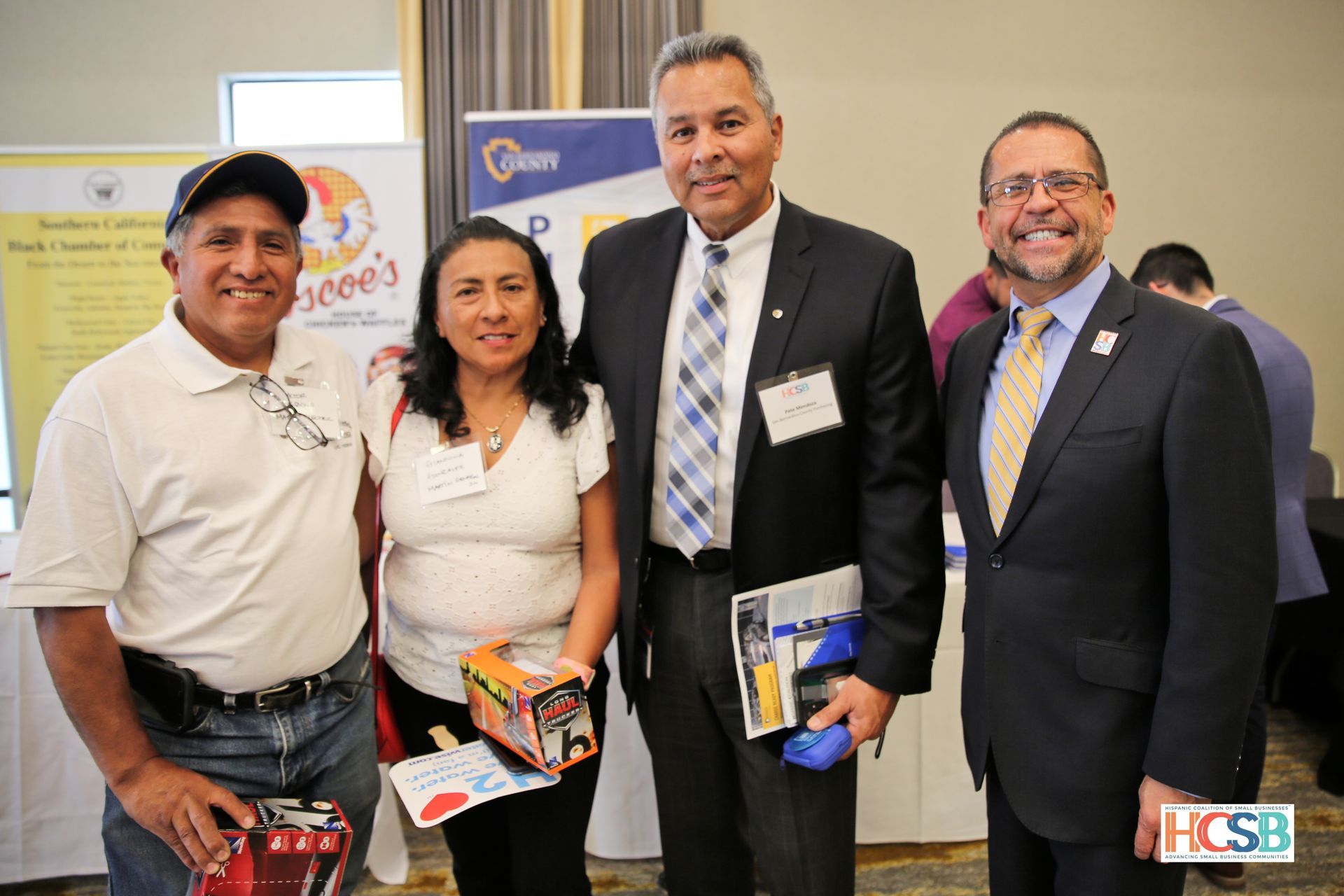 A group of people posing for a picture at a job fair