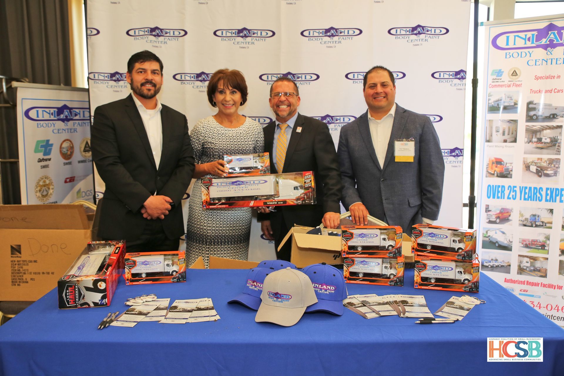 A group of people standing around a table holding boxes