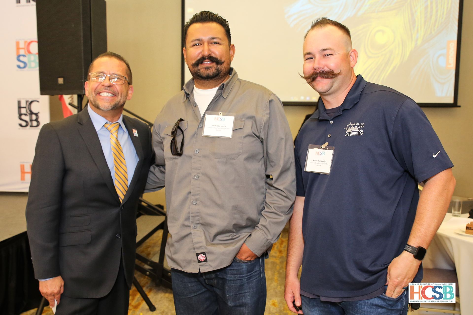 Three men with mustaches are posing for a picture.