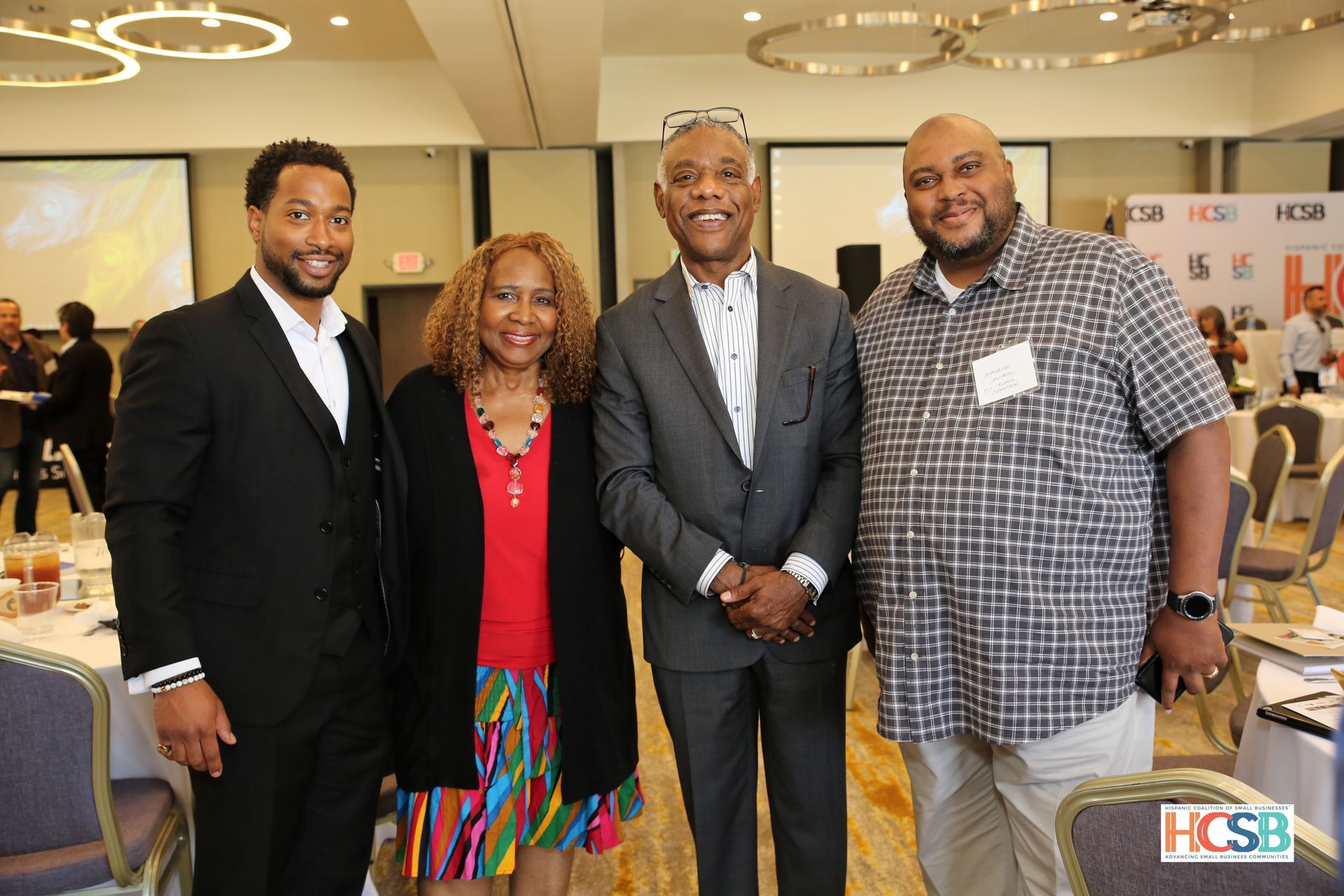 A group of people are posing for a picture in a room.