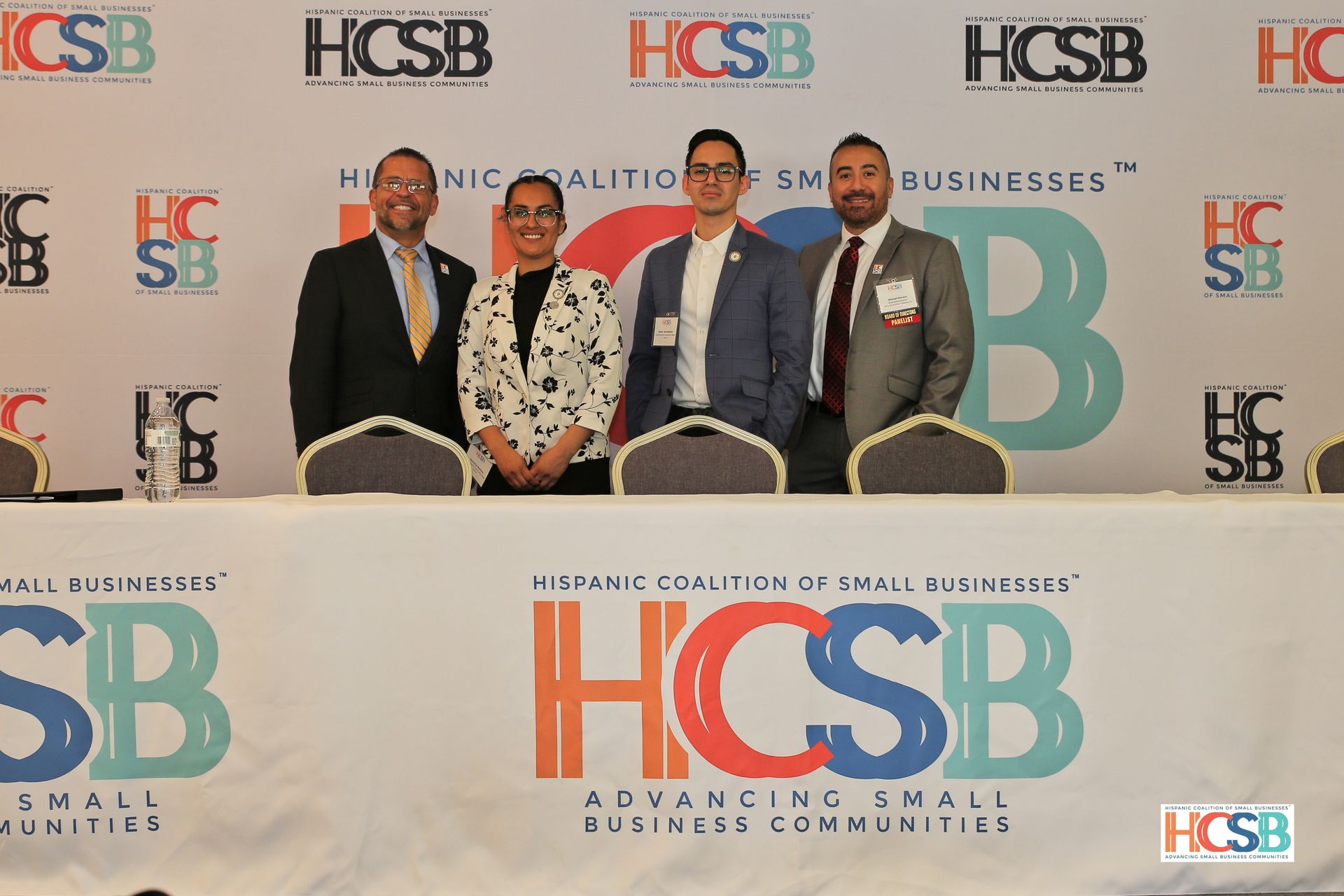 A group of people standing in front of a hcsb banner