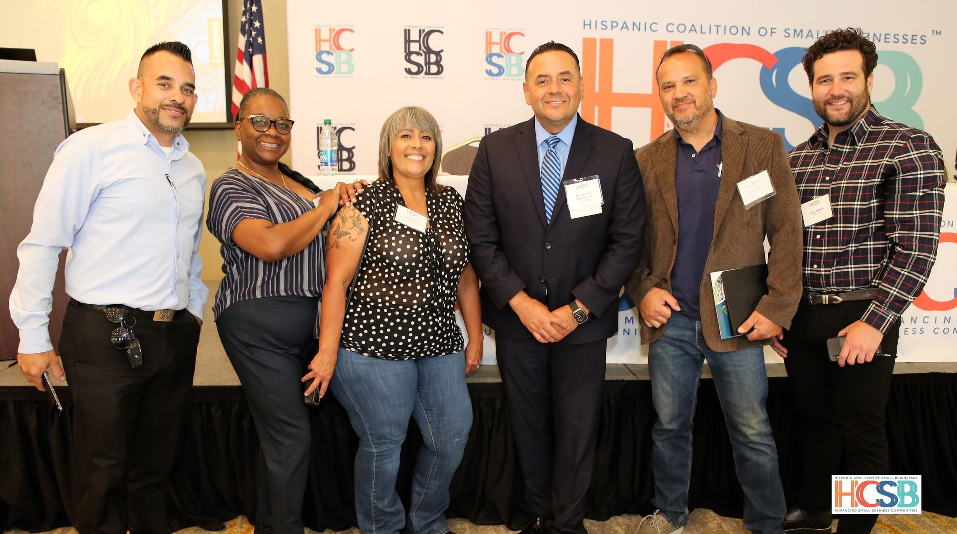 A group of people are posing for a picture in front of a sign that says ucsb.