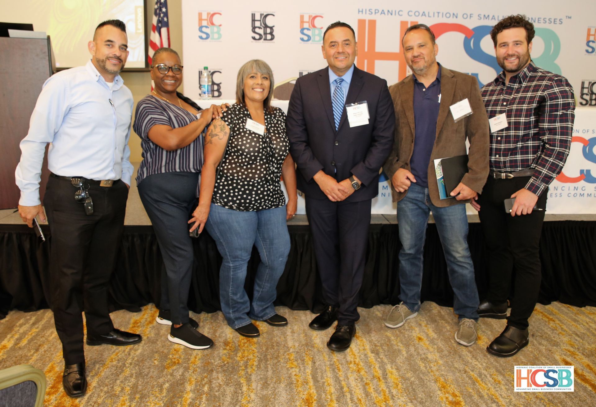 A group of people are posing for a picture in a room.