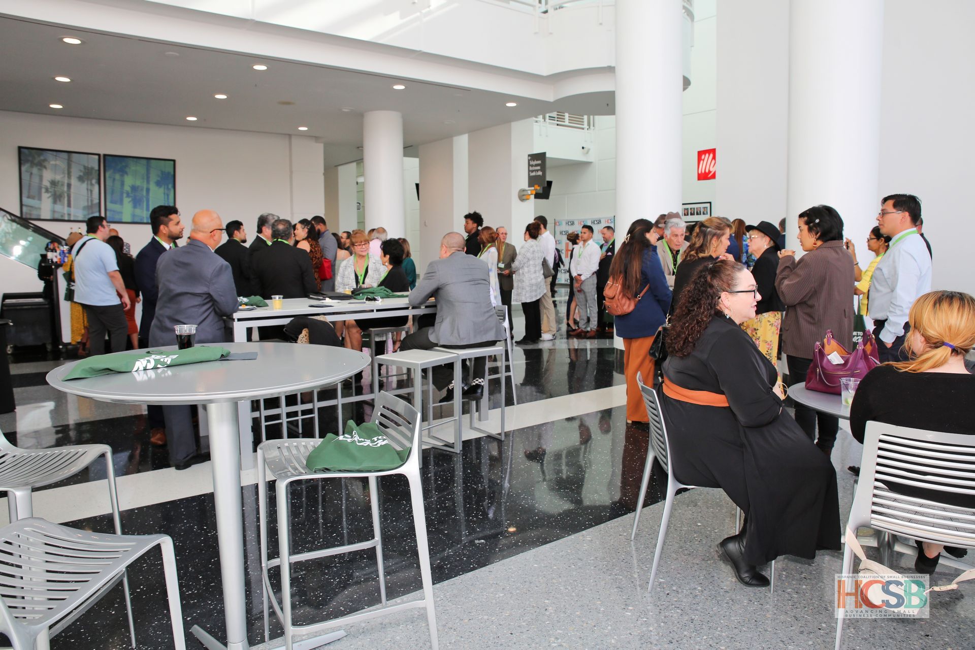 A group of people are sitting at tables in a room.