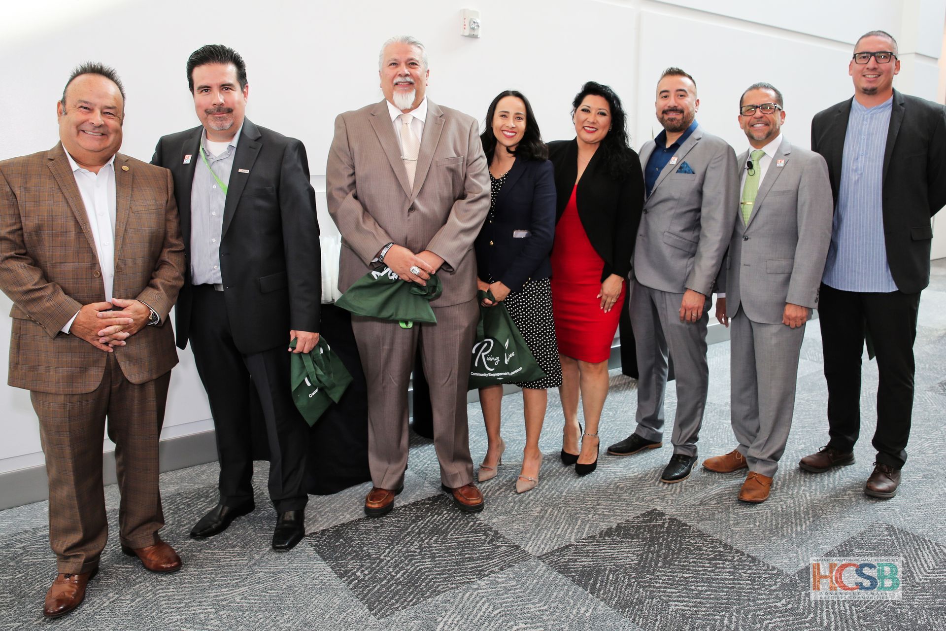 A group of people in suits are posing for a picture.